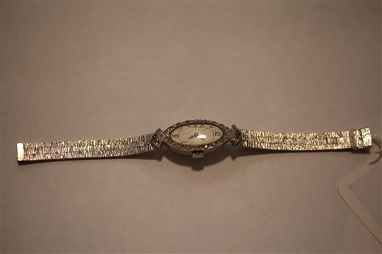 A ladys late 1920s 18ct white gold and diamond set cocktail watch,